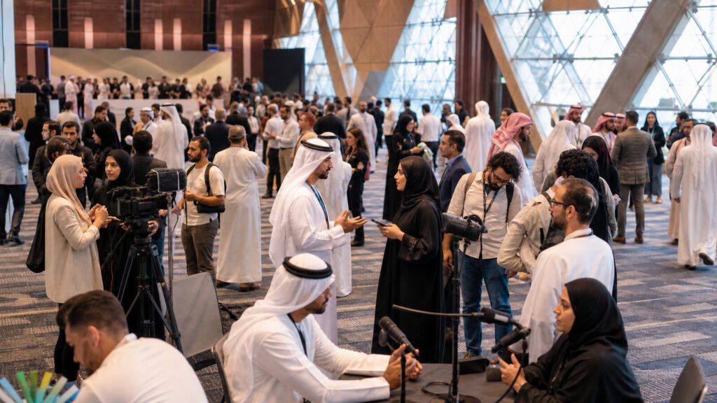 Arab journalists, creators and communication professionals networking inside a large modern Dubai conference venue