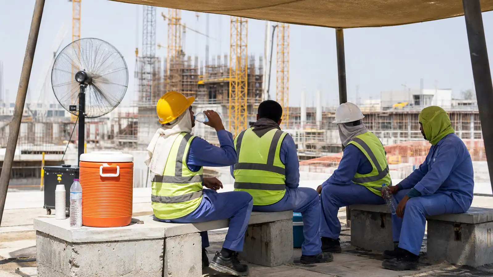 UAE workers taking a shaded water break at a safe worksite
